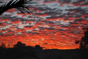 A fiery Hawke's Bay sunset reflects off the broken clouds.